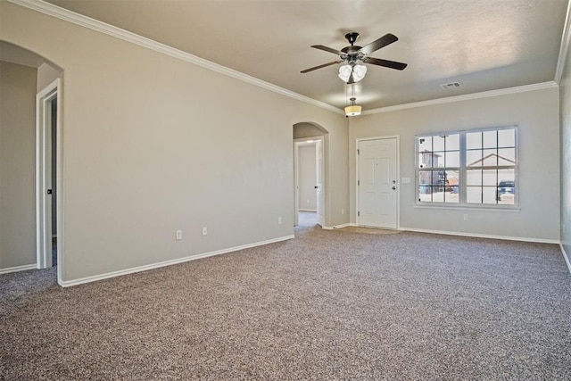 spare room featuring ornamental molding, ceiling fan, and carpet flooring