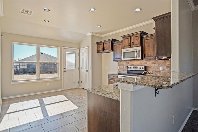 kitchen with appliances with stainless steel finishes, stone countertops, a breakfast bar, tasteful backsplash, and kitchen peninsula