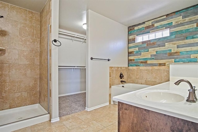 bathroom featuring plus walk in shower and sink