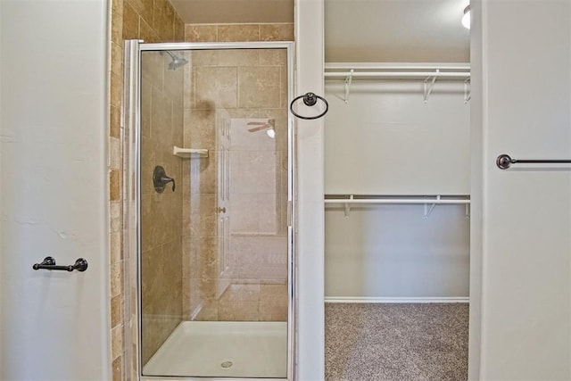 bathroom featuring a shower with door