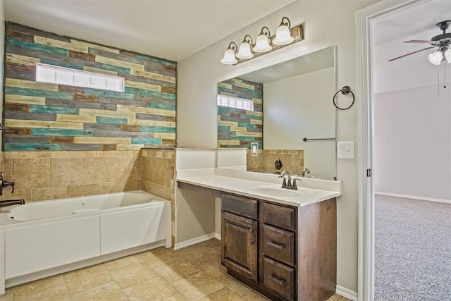 bathroom featuring ceiling fan, a tub to relax in, and vanity