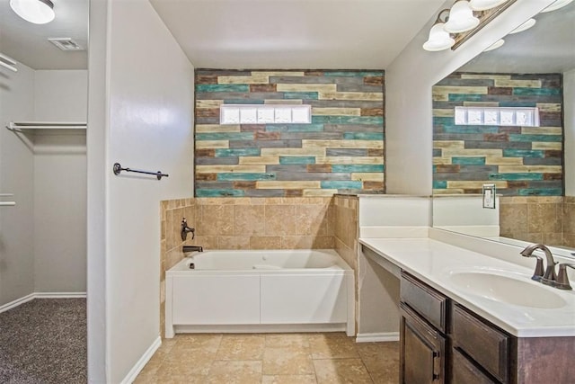 bathroom with vanity and a washtub