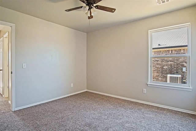 carpeted empty room with a wealth of natural light and ceiling fan