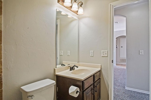 bathroom featuring vanity and toilet