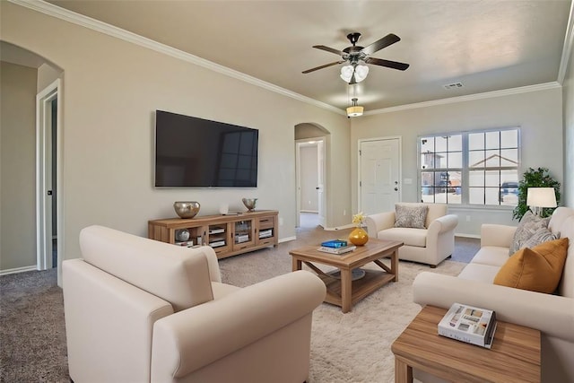 carpeted living room with crown molding and ceiling fan