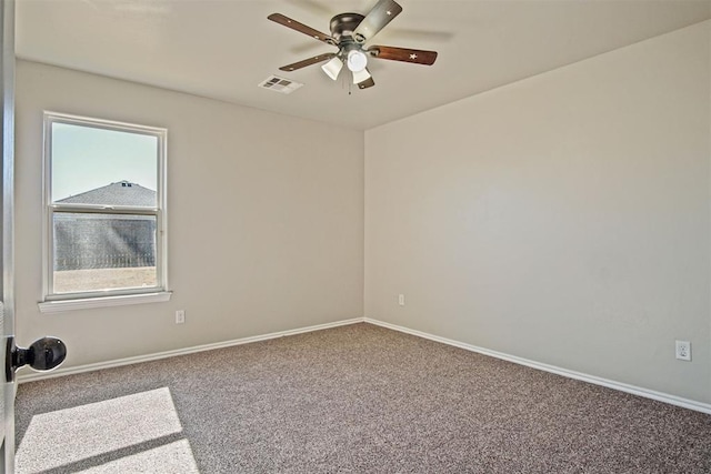 carpeted spare room with ceiling fan