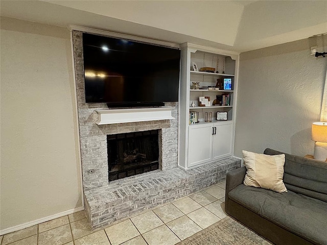 living room with light tile patterned flooring, lofted ceiling, and a brick fireplace