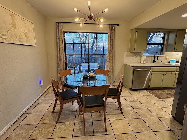 tiled dining space with sink and a chandelier