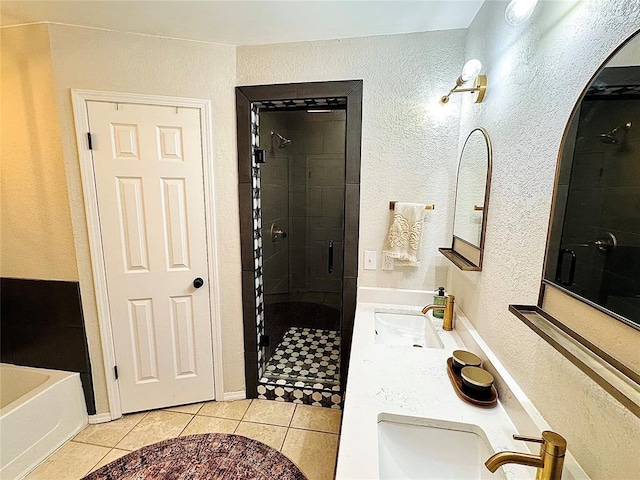 bathroom with tile patterned floors, separate shower and tub, and vanity