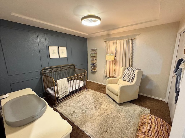 carpeted bedroom with a crib