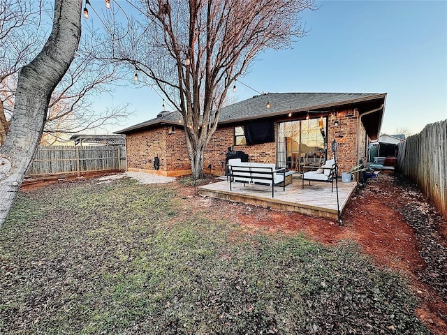 back of house with outdoor lounge area and a patio