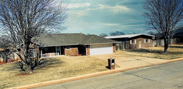 ranch-style home featuring a garage, a front lawn, concrete driveway, and brick siding