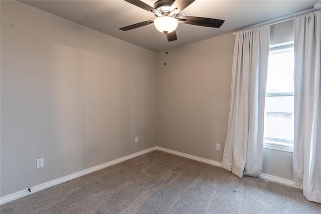 unfurnished room with light colored carpet and ceiling fan