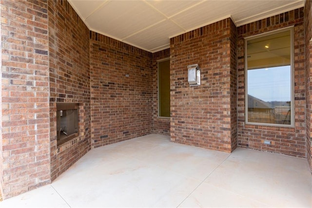 view of patio featuring an outdoor brick fireplace