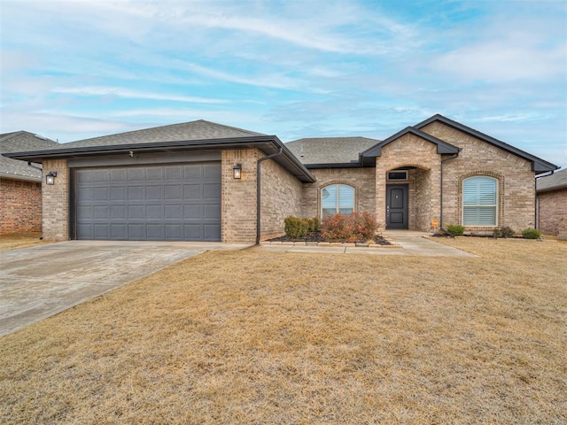 view of front of home with a garage and a front yard