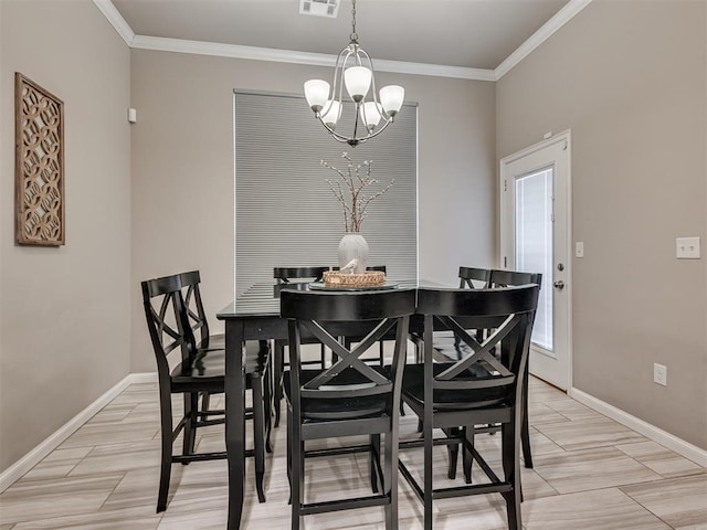 dining room with ornamental molding and a chandelier