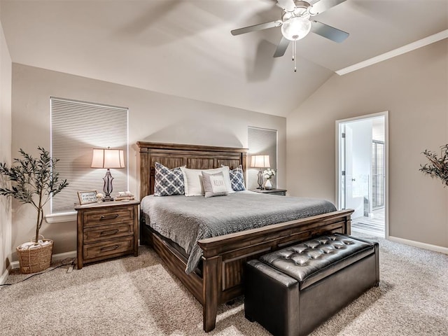 bedroom with ensuite bathroom, lofted ceiling, light colored carpet, and ceiling fan