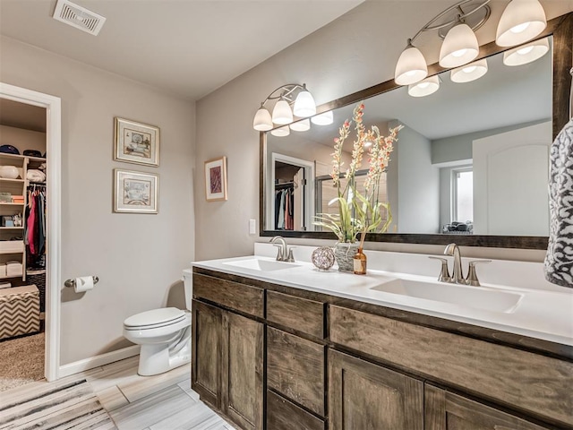 bathroom featuring vanity and toilet