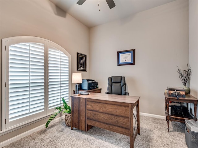 office space with light carpet and ceiling fan