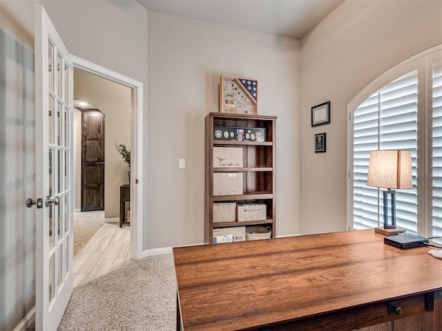 office space featuring light carpet and french doors