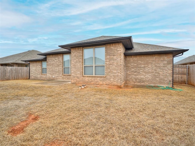 rear view of house with a yard and a patio area