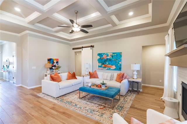 living room featuring coffered ceiling, light hardwood / wood-style flooring, and a barn door