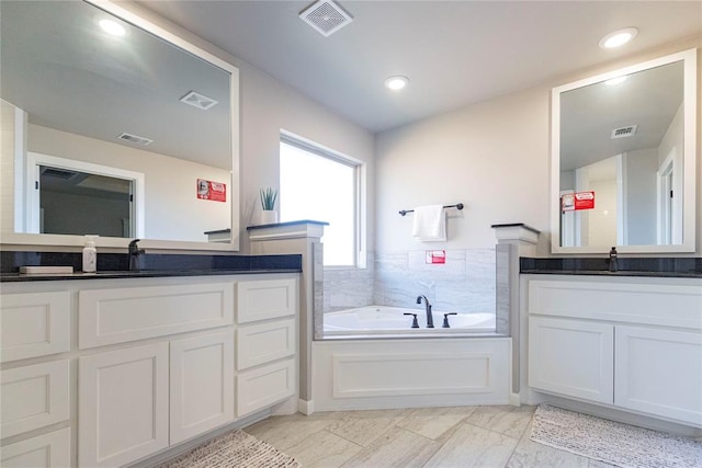 bathroom with vanity and a bath