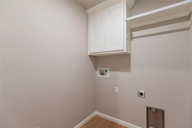 laundry area with cabinets, hookup for a washing machine, hardwood / wood-style floors, and electric dryer hookup