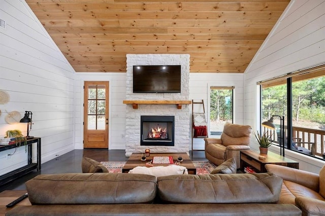 living room featuring high vaulted ceiling, a stone fireplace, wooden ceiling, and wood walls