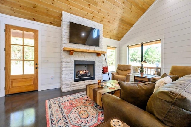 living room featuring wood ceiling, a stone fireplace, high vaulted ceiling, and wood walls