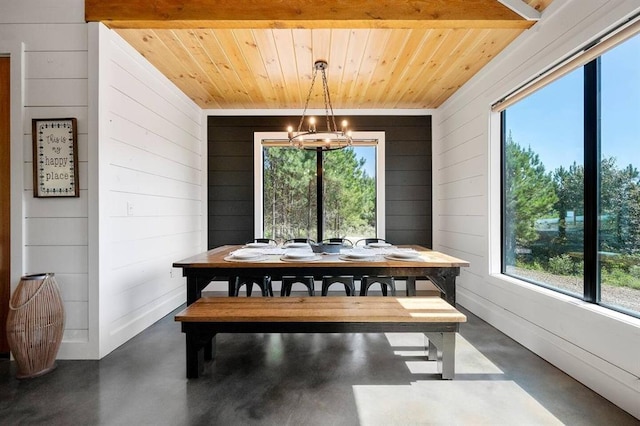 dining space with wood ceiling and an inviting chandelier