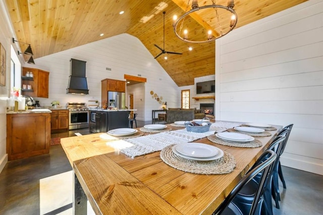 dining space featuring sink, high vaulted ceiling, wooden ceiling, ceiling fan, and a fireplace