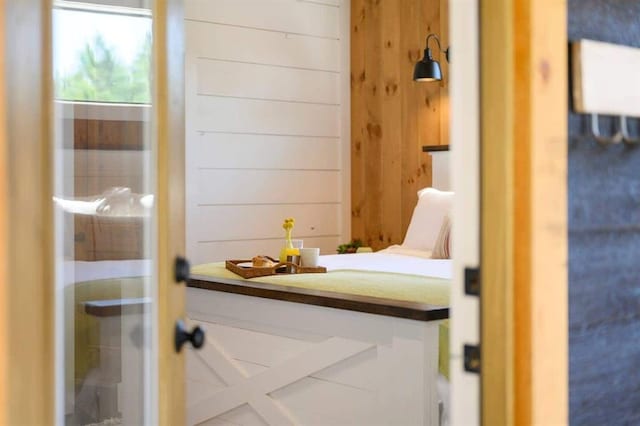 bathroom featuring wooden walls