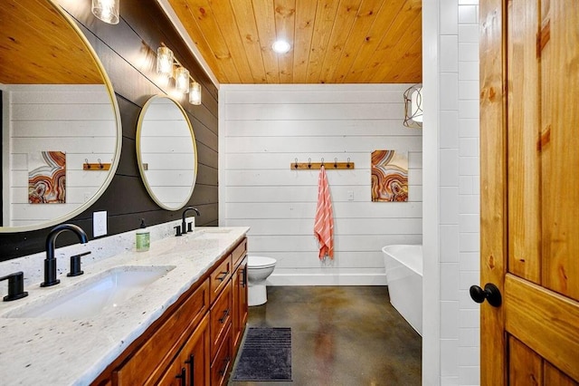 bathroom with concrete floors, a tub to relax in, vanity, wood ceiling, and toilet