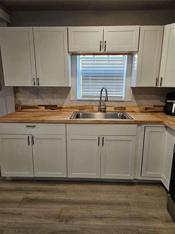 kitchen featuring wooden counters, sink, white cabinets, and dark hardwood / wood-style flooring