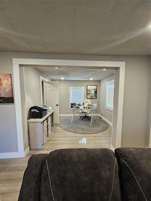 dining room with a textured ceiling and light hardwood / wood-style floors