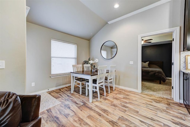 dining space with lofted ceiling and light hardwood / wood-style floors