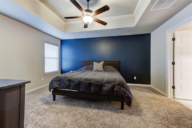 bedroom with crown molding, light carpet, ceiling fan, and a tray ceiling