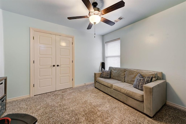 living room with ceiling fan and light colored carpet