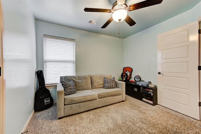 carpeted living room with ceiling fan