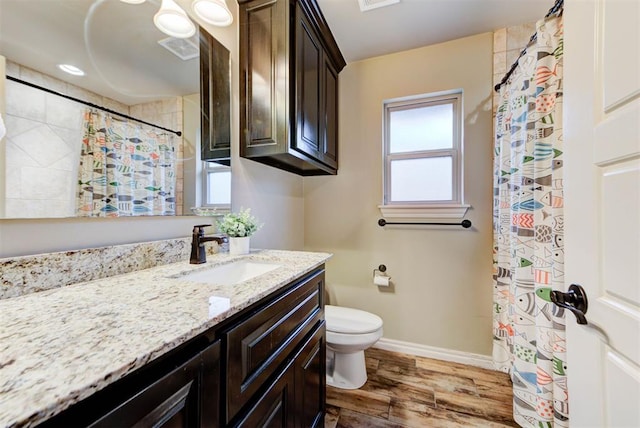 bathroom featuring vanity, toilet, and wood-type flooring