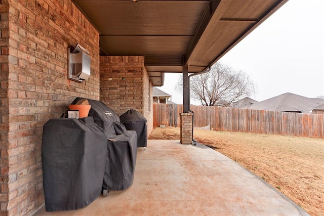 view of patio / terrace with grilling area and an AC wall unit