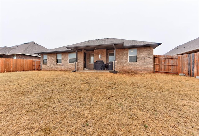 back of house with a yard