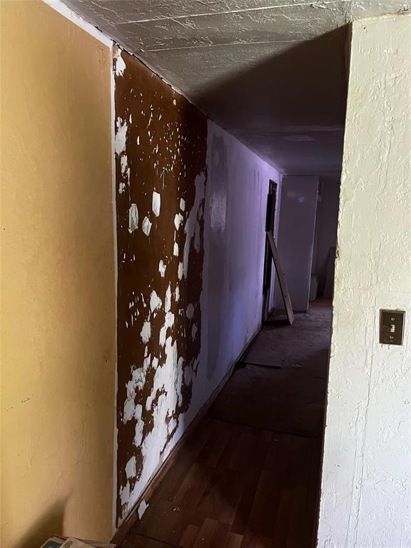 hallway with hardwood / wood-style flooring