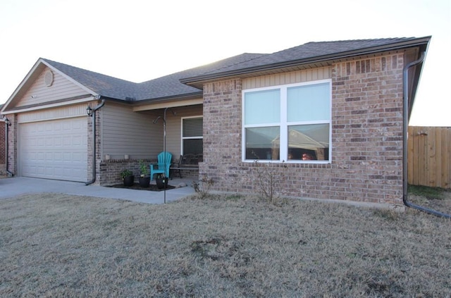 exterior space featuring a garage and a front yard