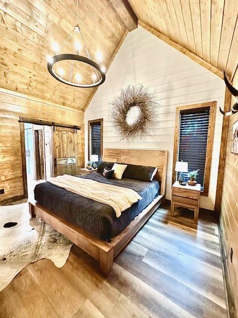 bedroom featuring wood ceiling, high vaulted ceiling, wooden walls, hardwood / wood-style flooring, and beam ceiling