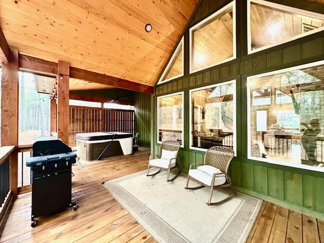 sunroom featuring vaulted ceiling and wooden ceiling