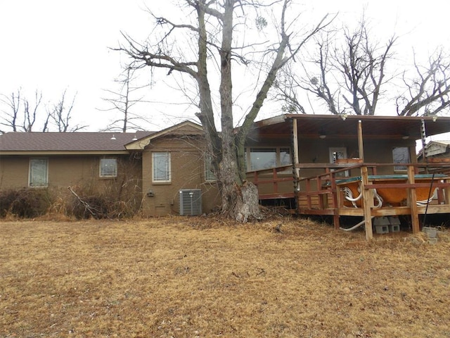 rear view of property with a wooden deck and central AC