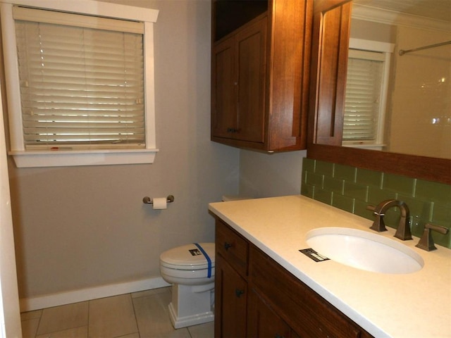 bathroom with walk in shower, toilet, tasteful backsplash, vanity, and tile patterned flooring