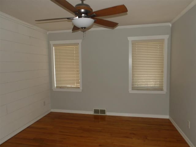 spare room featuring ornamental molding, ceiling fan, and dark hardwood / wood-style flooring